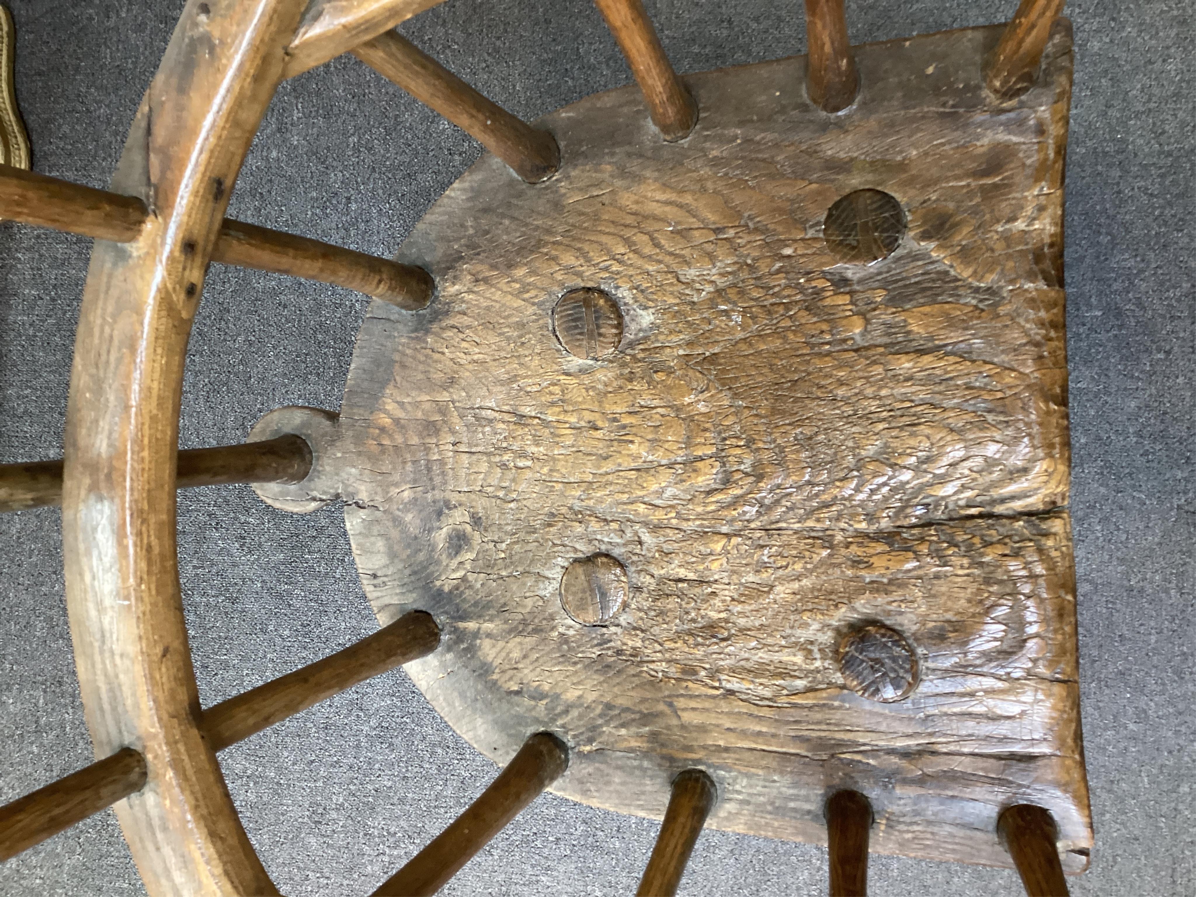 An 18th or 19th century primitive ash and elm Windsor armchair